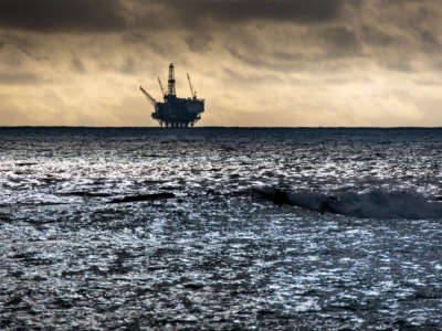 An offshore oil rig is viewed from Refugio Beach State Park as a storm gathers along the horizon on December 26, 2021, in Goleta, California.
