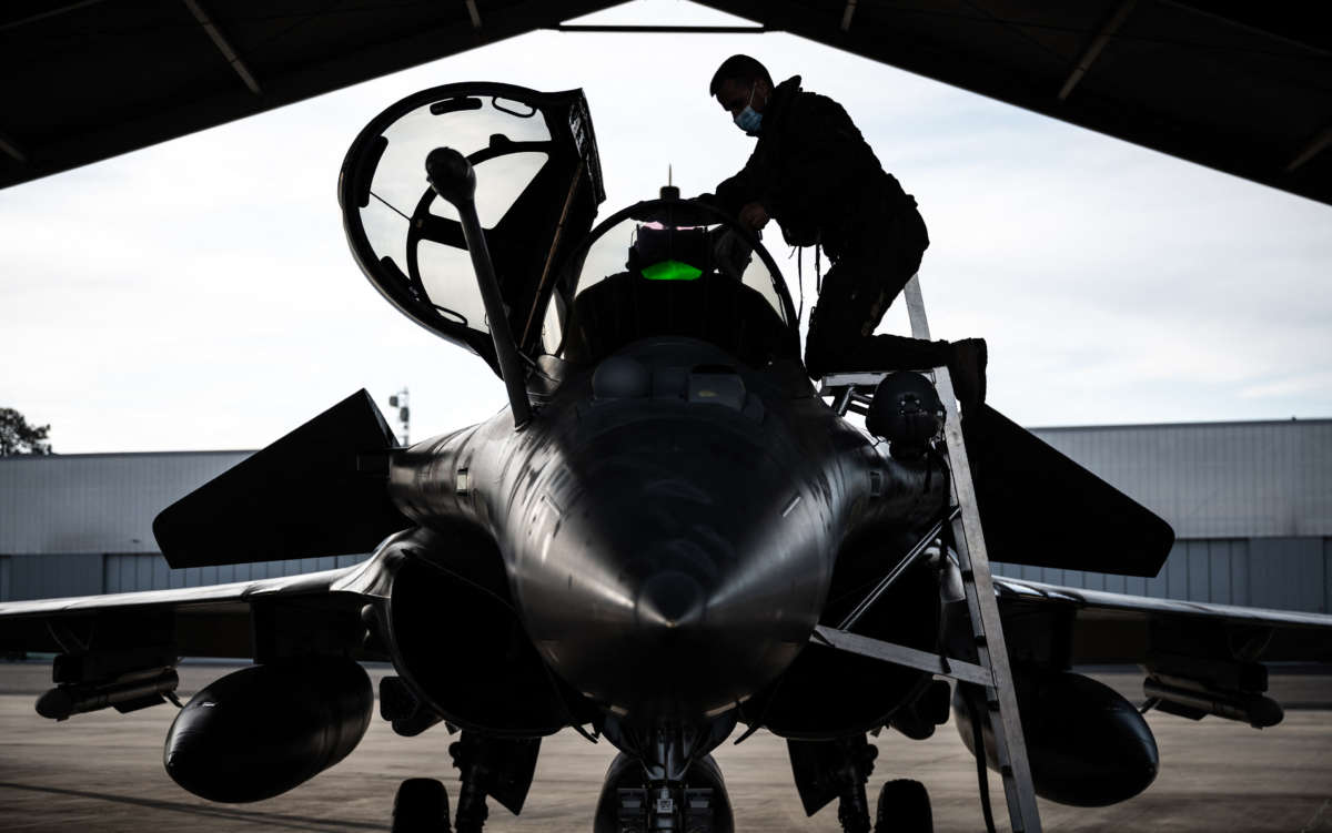 A Rafale fighter jet pilot inspects his aircraft prior to taking off for a daily NATO border watch mission sortie over Poland, at the Mont-de-Marsan airbase in southwestern France, on March 1, 2022.