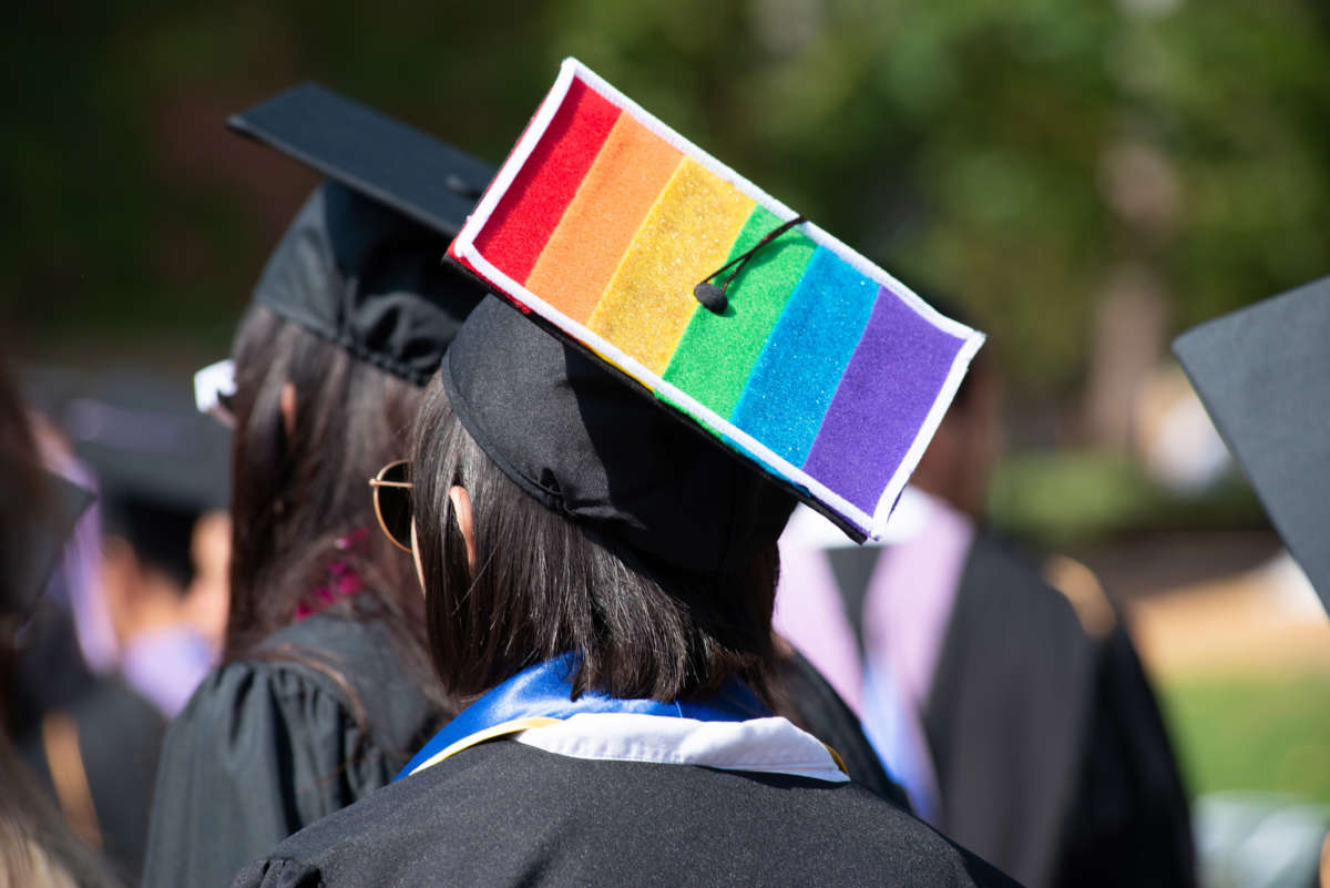 Graduate wearing cap with LGBTQ flag on it