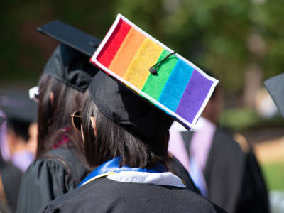 Graduate wearing cap with LGBTQ flag on it