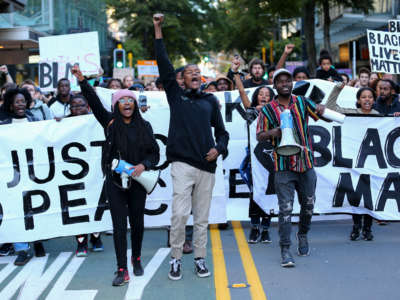 Protestors march down Willis Street during a protest in support of the Black Lives Matter movement on June 14, 2020, in Wellington, New Zealand.