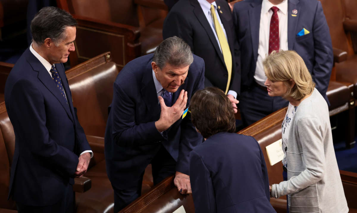 Sen. Joe Manchin talks with Senators Mitt Romney, Susan Collins and Lisa Murkowski before President Joe Biden delivers the State of the Union address during a joint session of Congress in the U.S. Capitol’s House Chamber on March 1, 2022, in Washington, D.C.