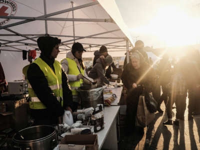 Volunteers distribute food and other items to refugees arriving at the Lviv Central Train Station on March 10, 2022.