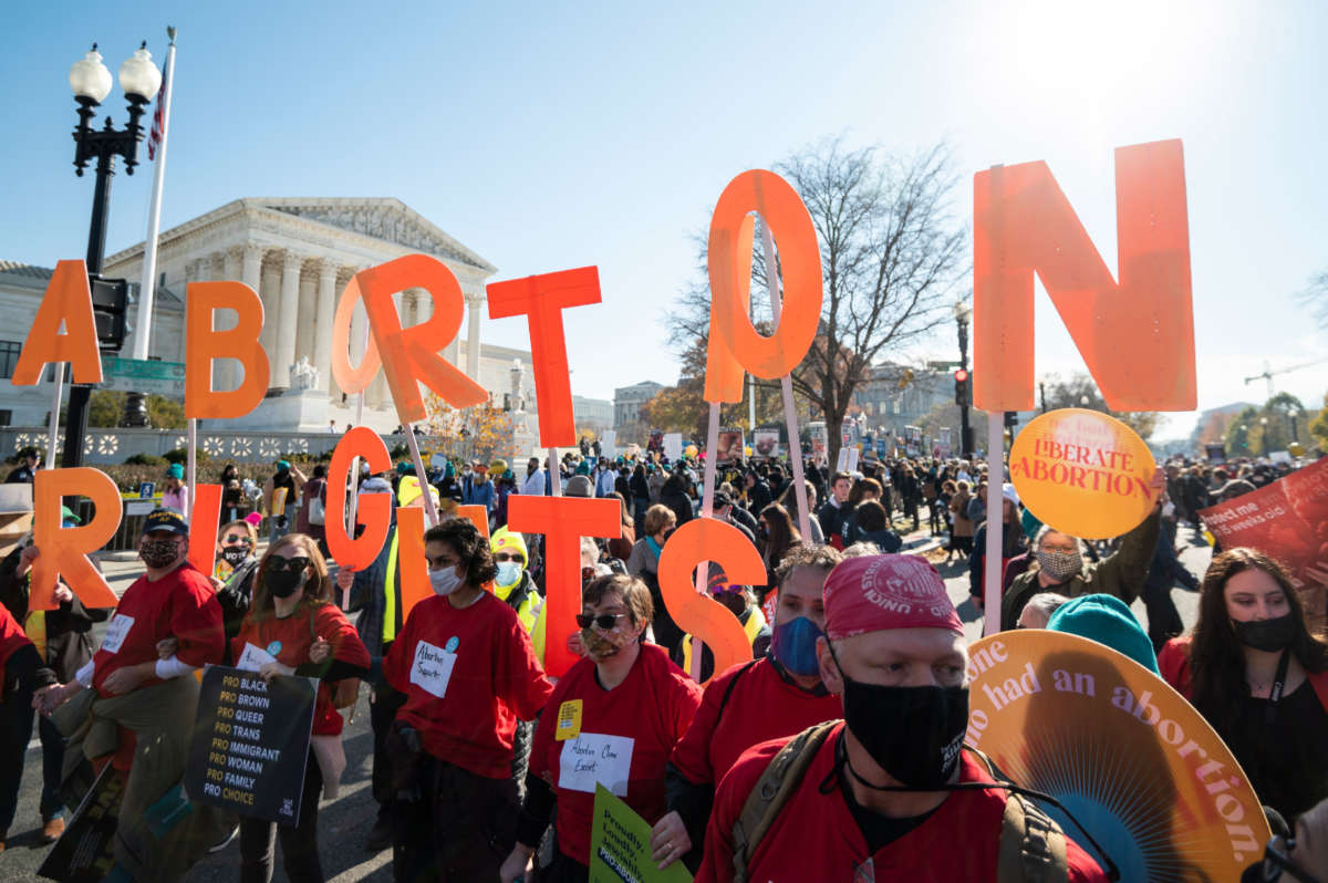 Reproductive rights activists hold abortion rights cut out letters outside the Supreme Court building in Washington, D.C., on December 1, 2021.