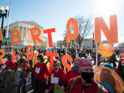 Reproductive rights activists hold abortion rights cut out letters outside the Supreme Court building in Washington, D.C., on December 1, 2021.