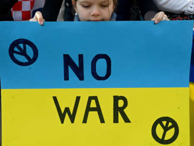 A girl with an anti-war message takes part in a protest in support for Ukraine following Russia's invasion of the country, in Zagreb's main city square on March 5, 2022.