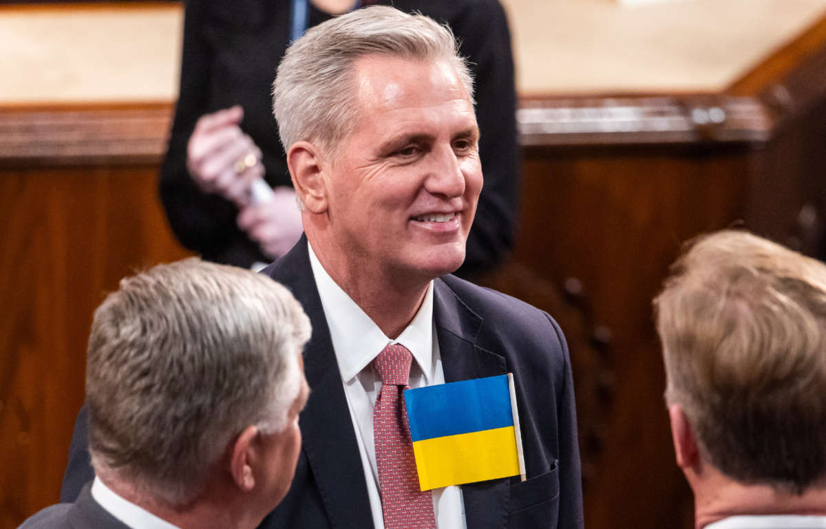 House Minority Leader Kevin McCarthy wears a Ukrainian flag before the State of the Union address by President Joe Biden during a joint session of Congress in the U.S. Capitol’s House Chamber on March 1, 2022, in Washington, D.C.