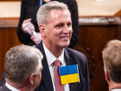 House Minority Leader Kevin McCarthy wears a Ukrainian flag before the State of the Union address by President Joe Biden during a joint session of Congress in the U.S. Capitol’s House Chamber on March 1, 2022, in Washington, D.C.