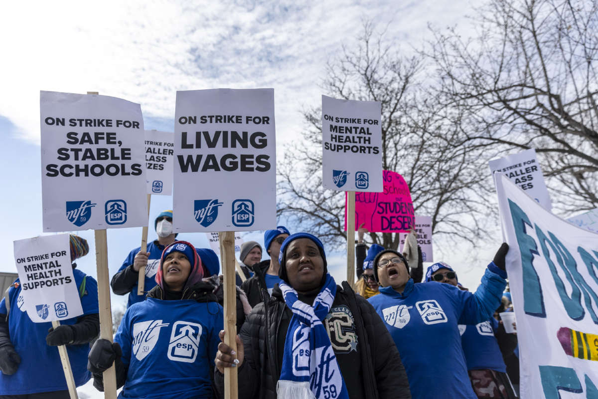 Minneapolis school teachers hold placards during the strike in front of the Justice Page Middle school in Minneapolis, Minnesota, on March 8, 2022.