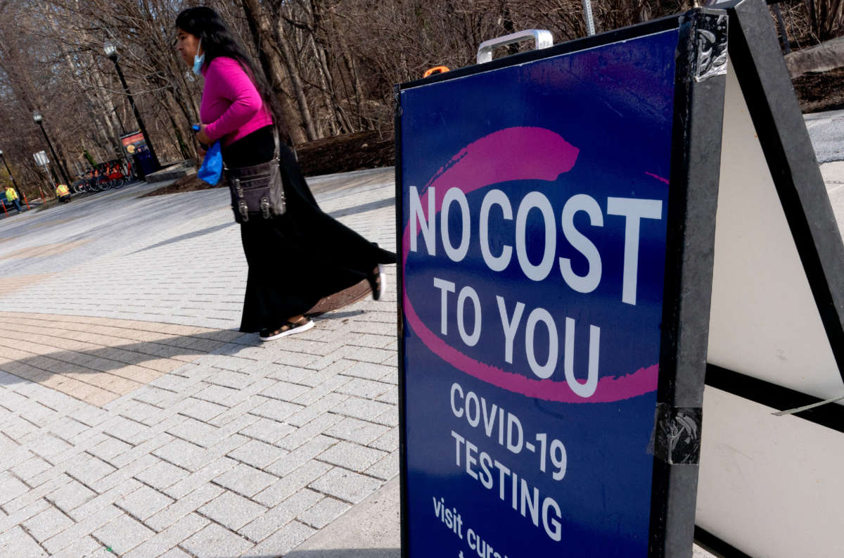 A person walks past a COVID-19 testing location in Arlington, Virginia, on March 16, 2022.