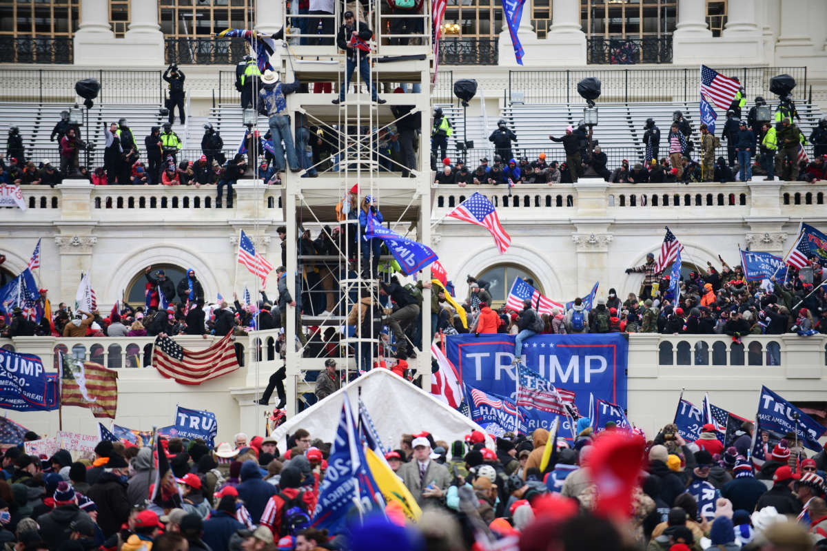 Supporters of President Donald Trump storm the U.S. Capitol and surrounding statues and scaffoldings set up for the inauguration for President-elect Joseph Biden in Washington, D.C., January 6, 2021.