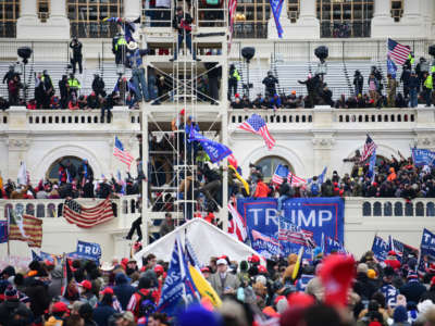 Supporters of President Donald Trump storm the U.S. Capitol and surrounding statues and scaffoldings set up for the inauguration for President-elect Joseph Biden in Washington, D.C., January 6, 2021.
