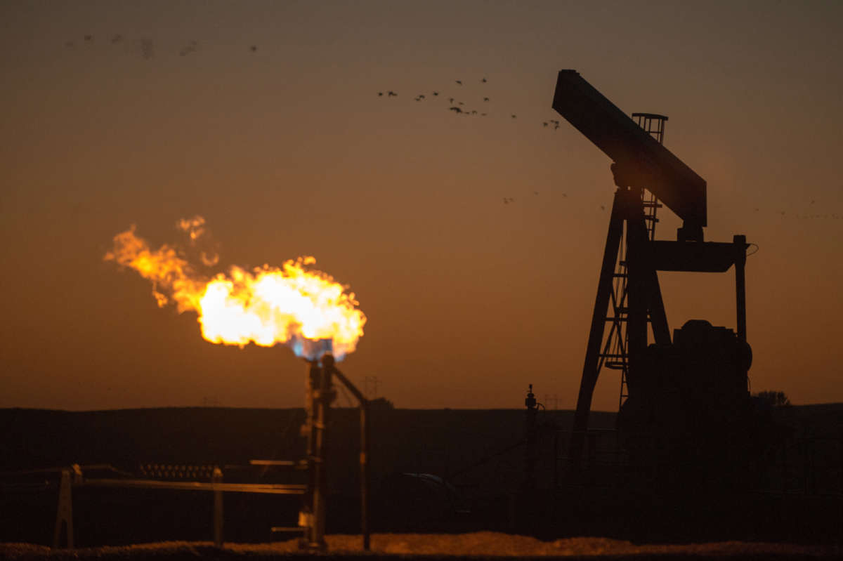 A flare burns in the Bakken oil field near Bainville, Montana, on September 12, 2013.