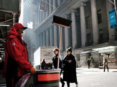 A man works on Wall Street near the New York Stock Exchange on March 11, 2022, in New York City.