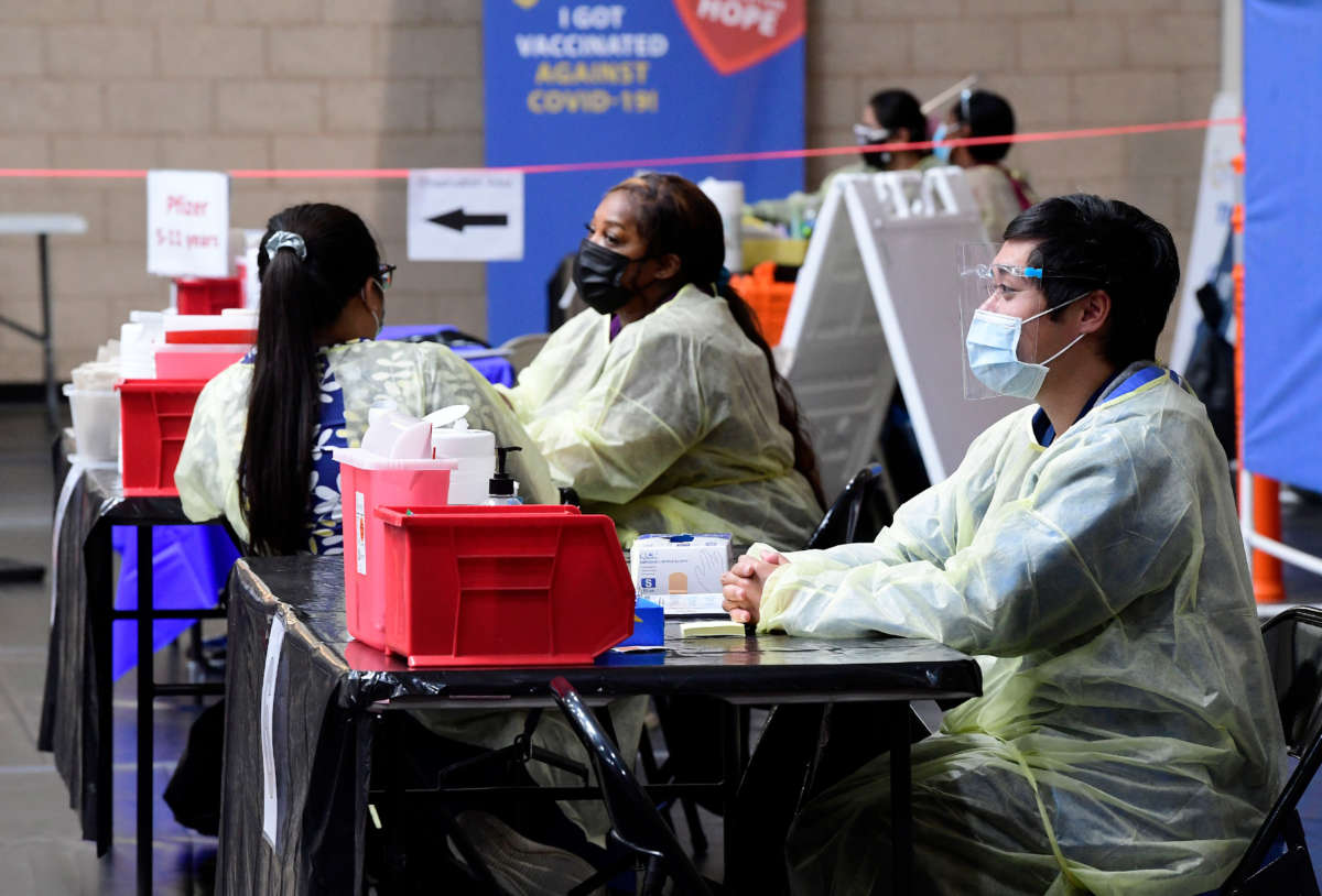 Nurses wait for COVID-19 vaccination patients to arrive at the Jessie Turner Health and Fitness in Fontana on March 22, 2022.