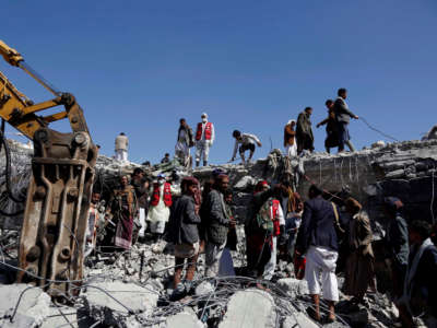 People search for survivors at a prison destroyed in an airstrike in Saada, Yemen, on January 22, 2022.