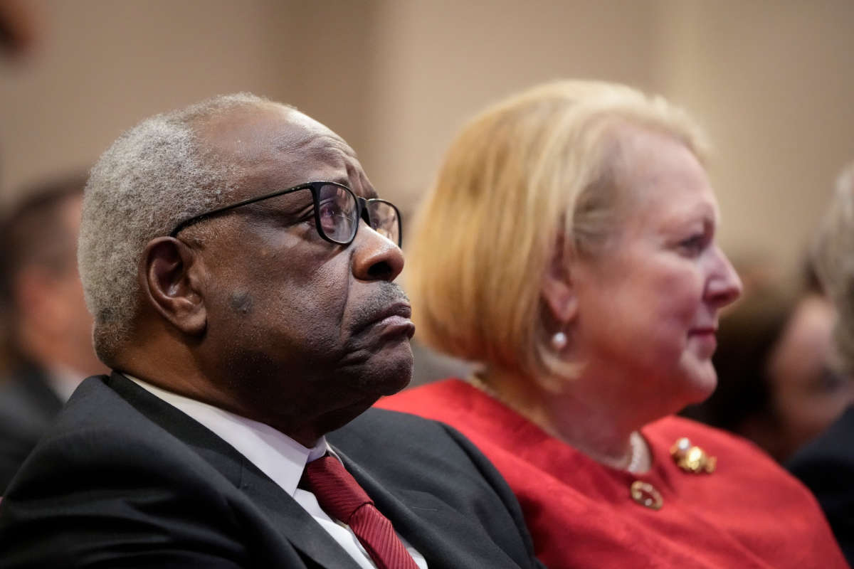 Associate Supreme Court Justice Clarence Thomas sits with his wife and conservative activist Virginia Thomas while he waits to speak at the Heritage Foundation on October 21, 2021, in Washington, D.C.