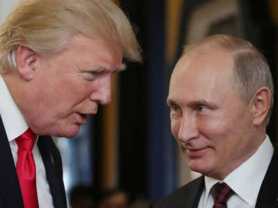 President Donald Trump chats with Russia's President Vladimir Putin as they attend the APEC Economic Leaders' Meeting in the central Vietnamese city of Danang on November 11, 2017.