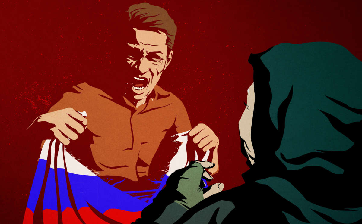 An enraged man tears up a Russian flag in front of an elderly woman