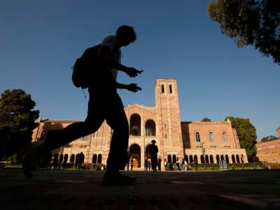 A student walks by Royce Hall on the campus of the University of California, Los Angeles (UCLA) on November 17, 2021.