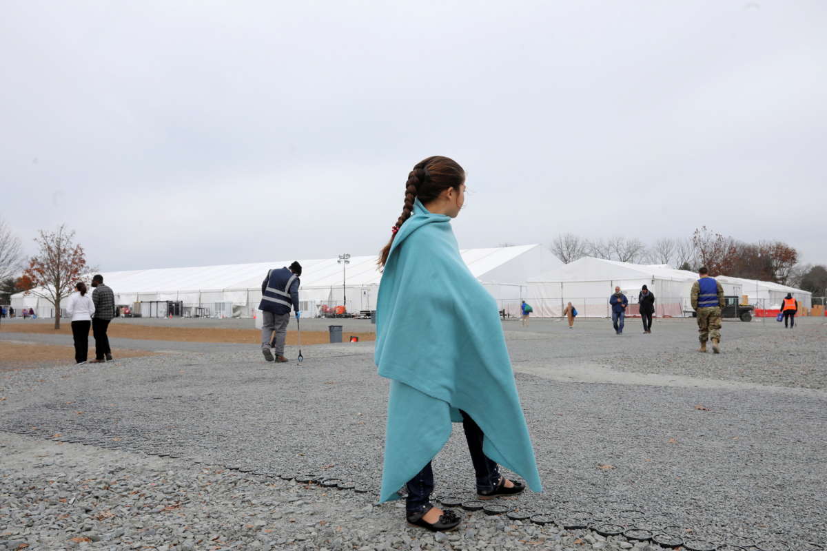 An Afghan girl looks on at temporary housing in Liberty Village on December 2, 2021, in Joint Base McGuire-Dix-Lakehurst, New Jersey.