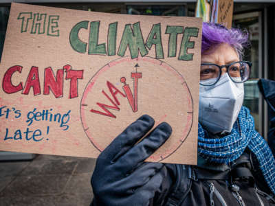 A protester is seen holding a sign outside the New York Governor's office on January 25, 2022, in New York City.