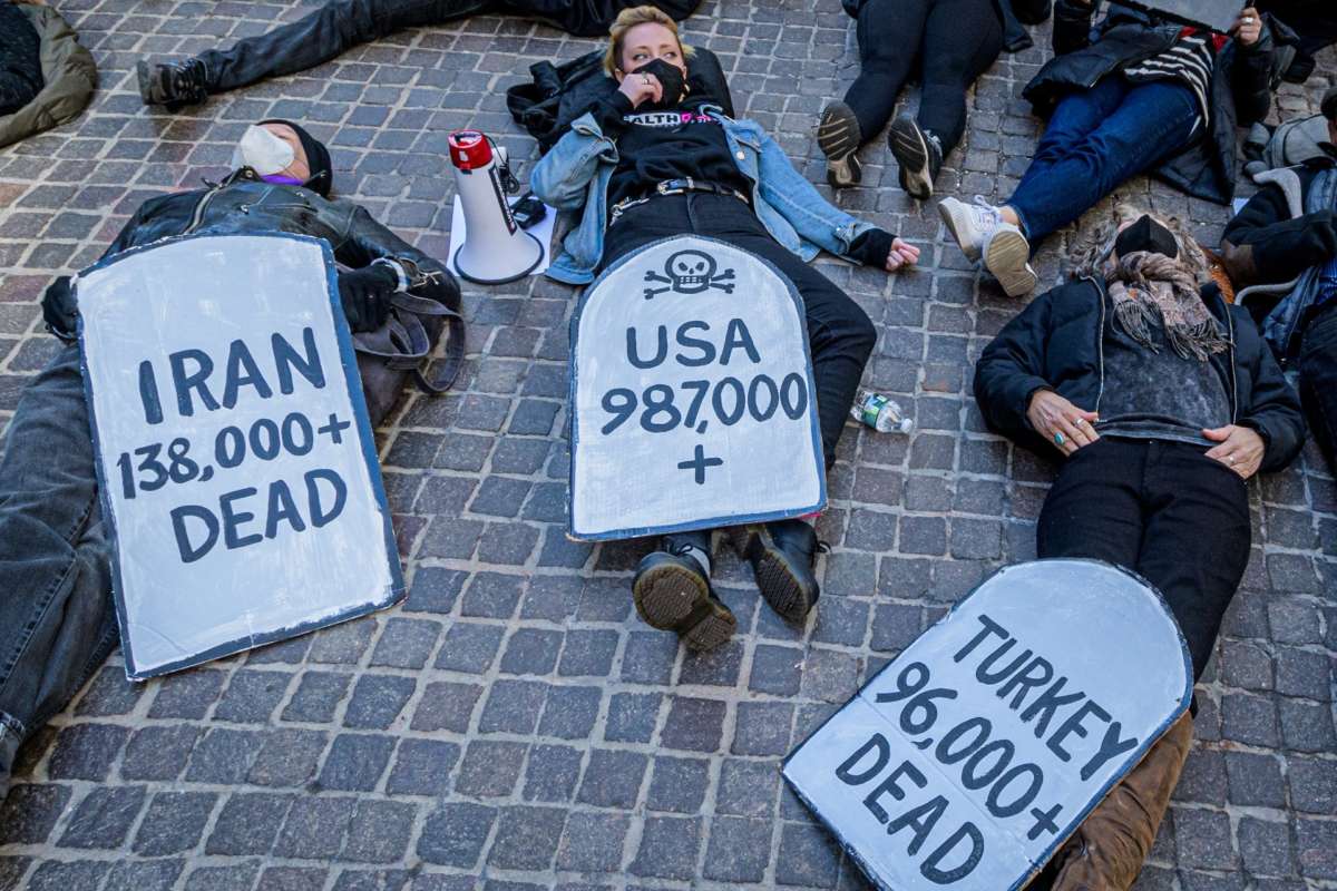 Protesters at a die-in against COVID inaction