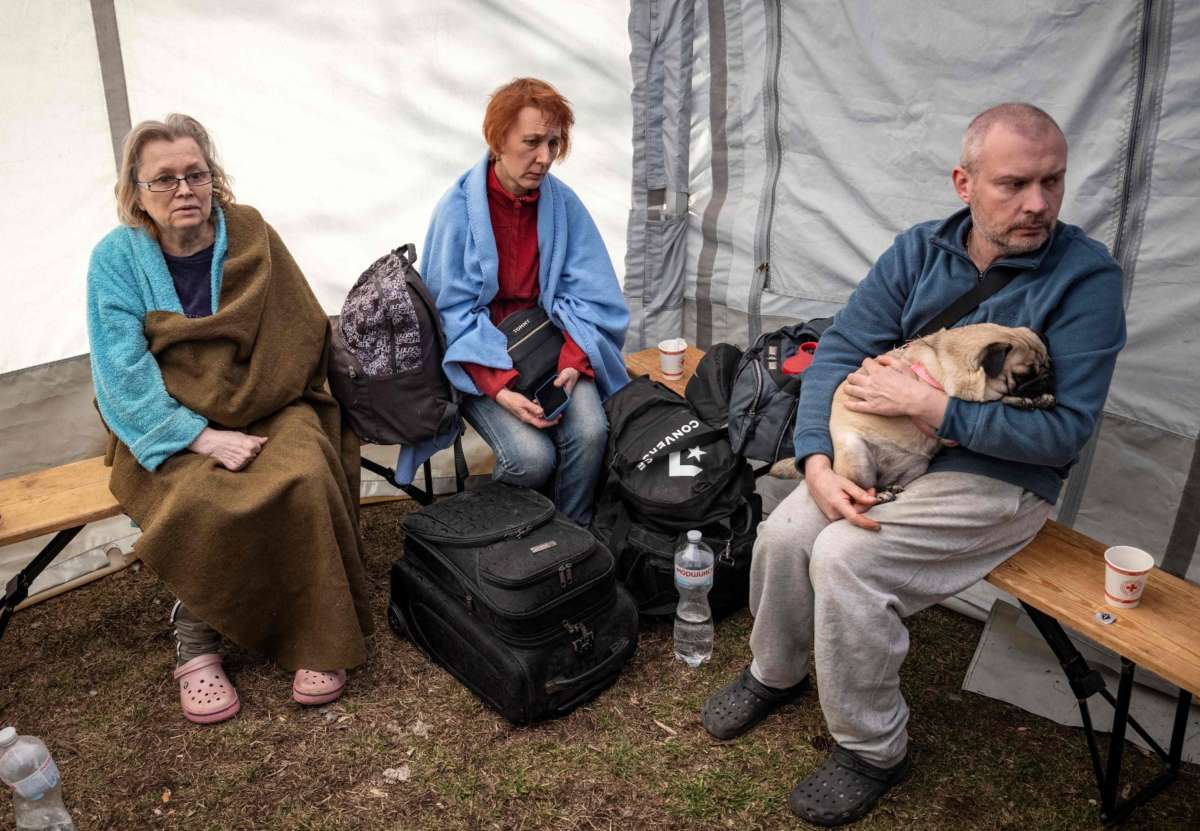 Kyiv residents sit in tent set up after building is hit with shrapnel