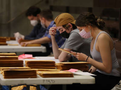 Election officials count early voting ballots at City Hall on November 2, 2021, in Boston, Massachusetts.