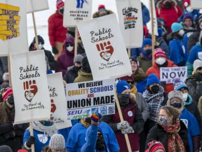 Teachers rally and march for better contracts in St. Paul, Minnesota, on February 12, 2022.