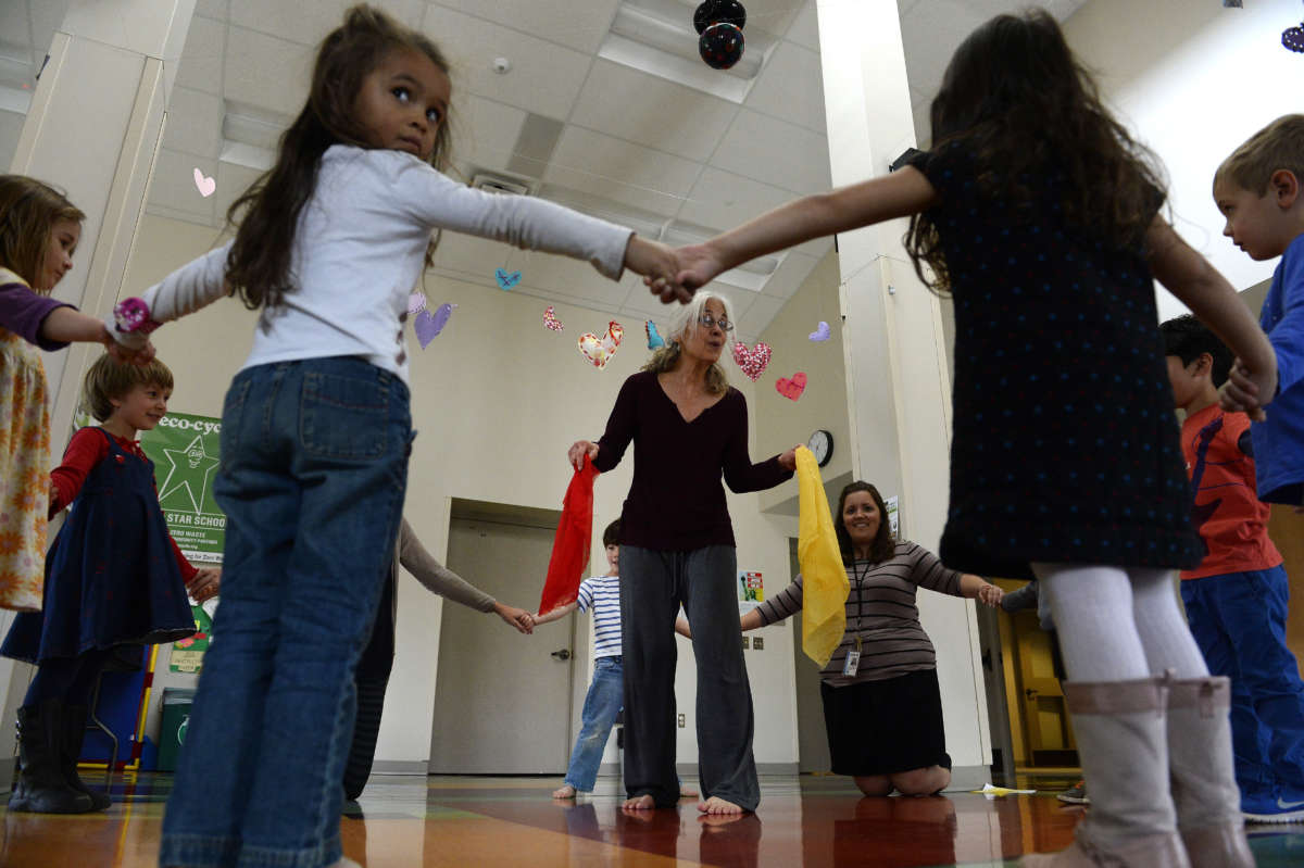 Teacher Toby Hankin leads preschoolers in dance during the Creative Movement Class at the Mapleton Early Childhood Center on March 30, 2016, in Boulder, Colorado.