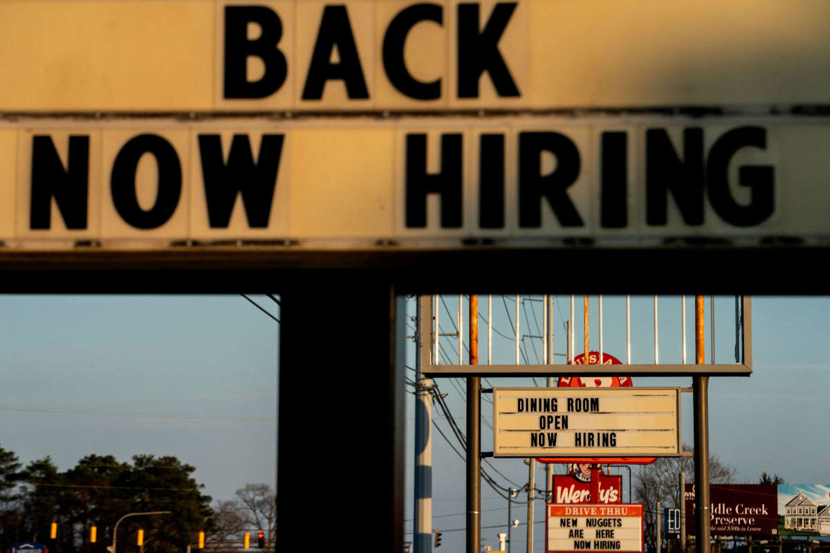Now Hiring signs are displayed in front of restaurants in Rehoboth Beach, Delaware, on March 19, 2022.