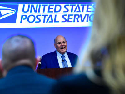 Postmaster General Louis DeJoy addresses soon to be Postmasters before they take the oath of office during a pledge ceremony at the General Mail Facility on March 16, 2022, in Denver, Colorado.