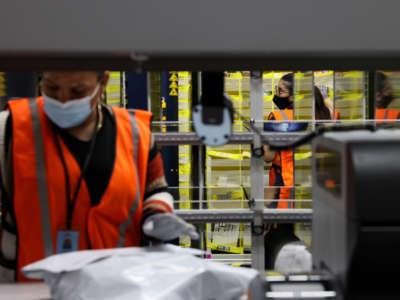 Amazon employees work in a fulfillment center in Bridgewater, Massachusetts, on March 16, 2022.