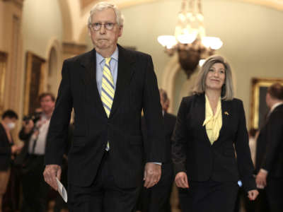 Senate Minority Leader Mitch McConnell and Sen. Joni Ernst arrive at a news conference following the weekly Senate Republican policy luncheon at the U.S. Capitol Building on April 5, 2022, in Washington, D.C.