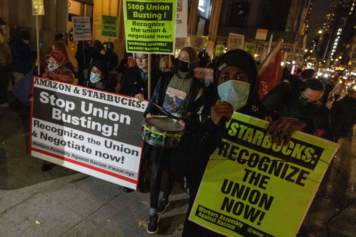 People march during a protest in support of Amazon and Starbucks workers in New York City on November 26, 2021.