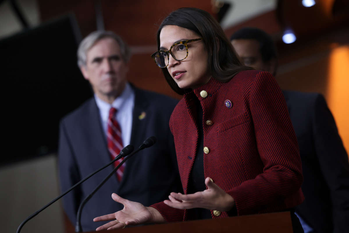 Rep. Alexandria Ocasio-Cortez, joined by Sen. Jeff Merkley, speaks on banning stock trades for members of Congress at news conference on Capitol Hill on April 7, 2022, in Washington, D.C.