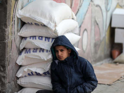 A Palestinian child is pictured at a food aid distribution center run by the United Nations Relief and Works Agency in Gaza City on March 16, 2022.