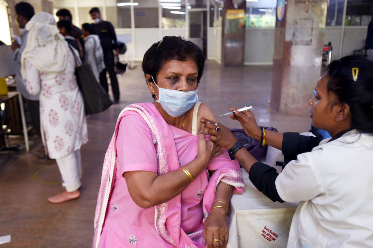 An elderly woman recieves a dose of the covid-19 vaccine