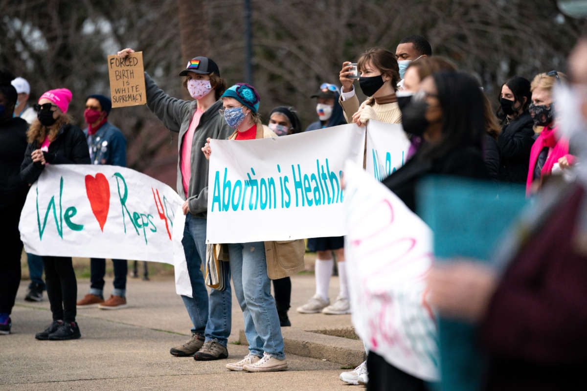 Demonstrators hold placards and banners during a press conference and protest by Democrats, who walked out during a debate on an anti-abortion bill in the House of Representatives in Columbia, South Carolina, on February 17, 2021.