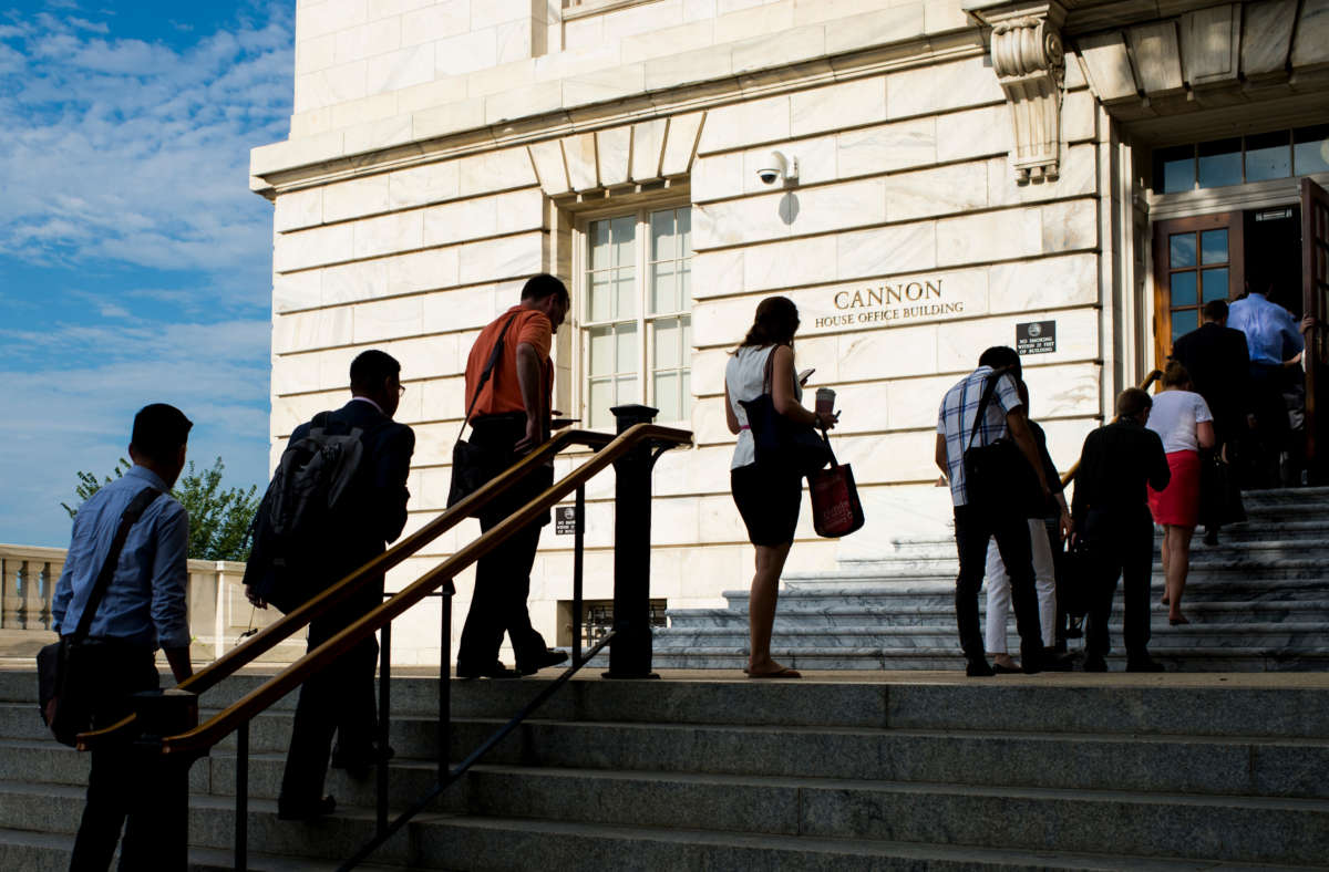 Congressional staffers wait in line to enter the Cannon House Office Building on July 20, 2015.