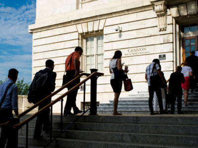 Congressional staffers wait in line to enter the Cannon House Office Building on July 20, 2015.