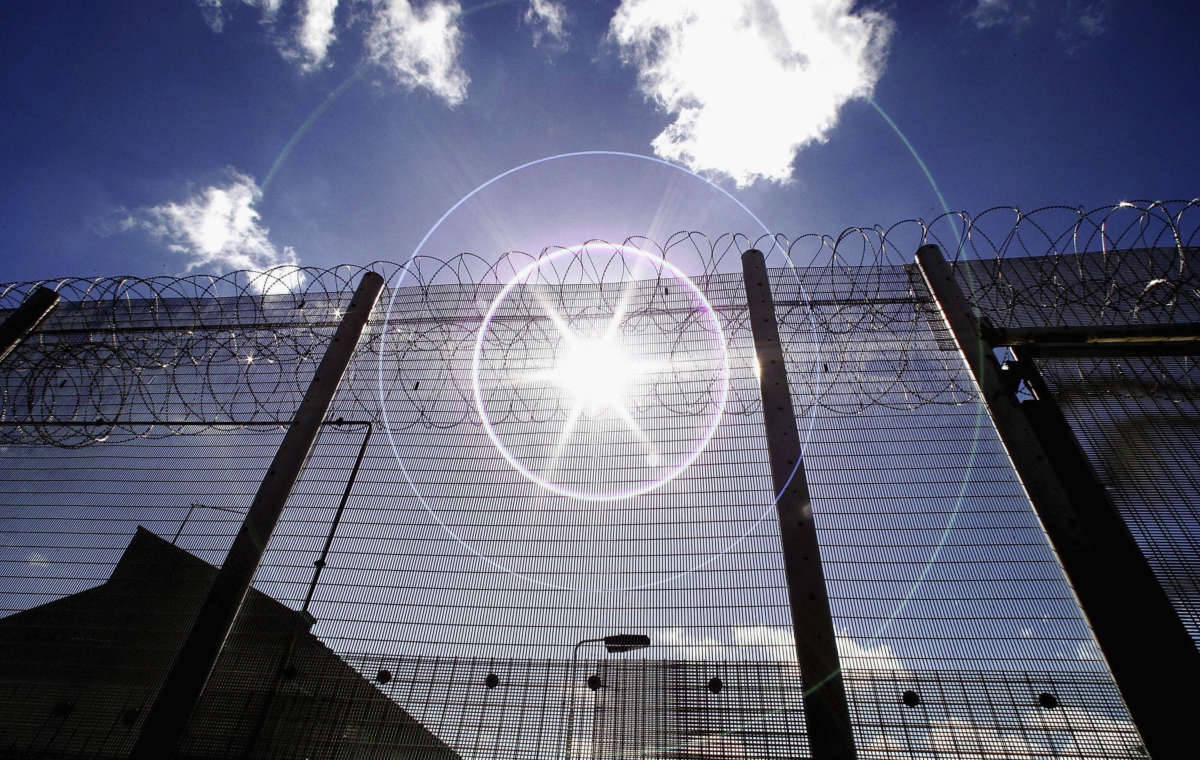 The sun shines through high security fencing surrounding Norwich Prison on August 25, 2005, in Norwich, England.