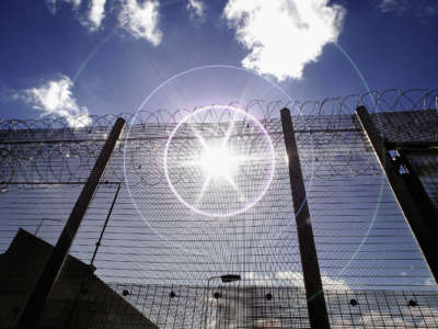 The sun shines through high security fencing surrounding Norwich Prison on August 25, 2005, in Norwich, England.