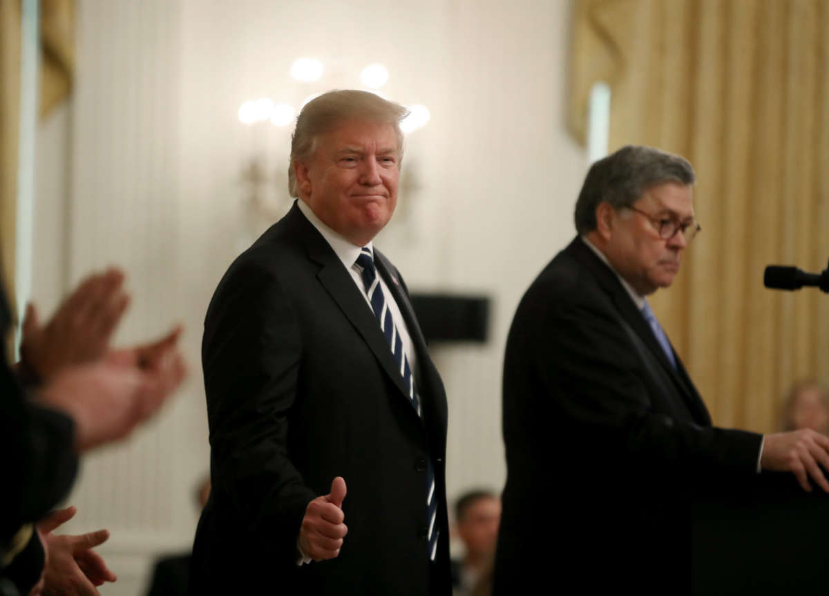 President Donald Trump, left, stands with Attorney General William Barr before the presentation of the Public Safety Officer Medals of Valor in the East Room of the White House on May 22, 2019, in Washington, D.C.