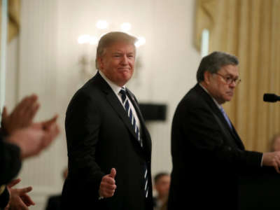 President Donald Trump, left, stands with Attorney General William Barr before the presentation of the Public Safety Officer Medals of Valor in the East Room of the White House on May 22, 2019, in Washington, D.C.