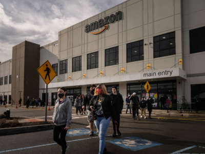Workers walk to cast their votes over whether or not to unionize, outside an Amazon warehouse in Staten Island on March 25, 2022.
