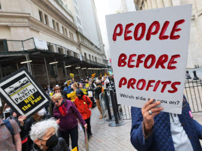 People participate in a march to Trinity Church for a moral Mass on April 11, 2022, in New York City.