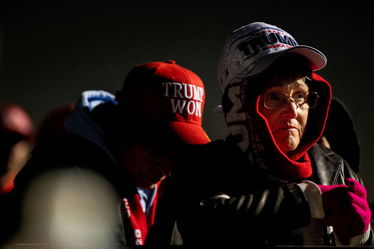 Supporters listen to former President Donald Trump speak during a rally at the Montgomery County Fairgrounds on January 29, 2022, in Conroe, Texas.