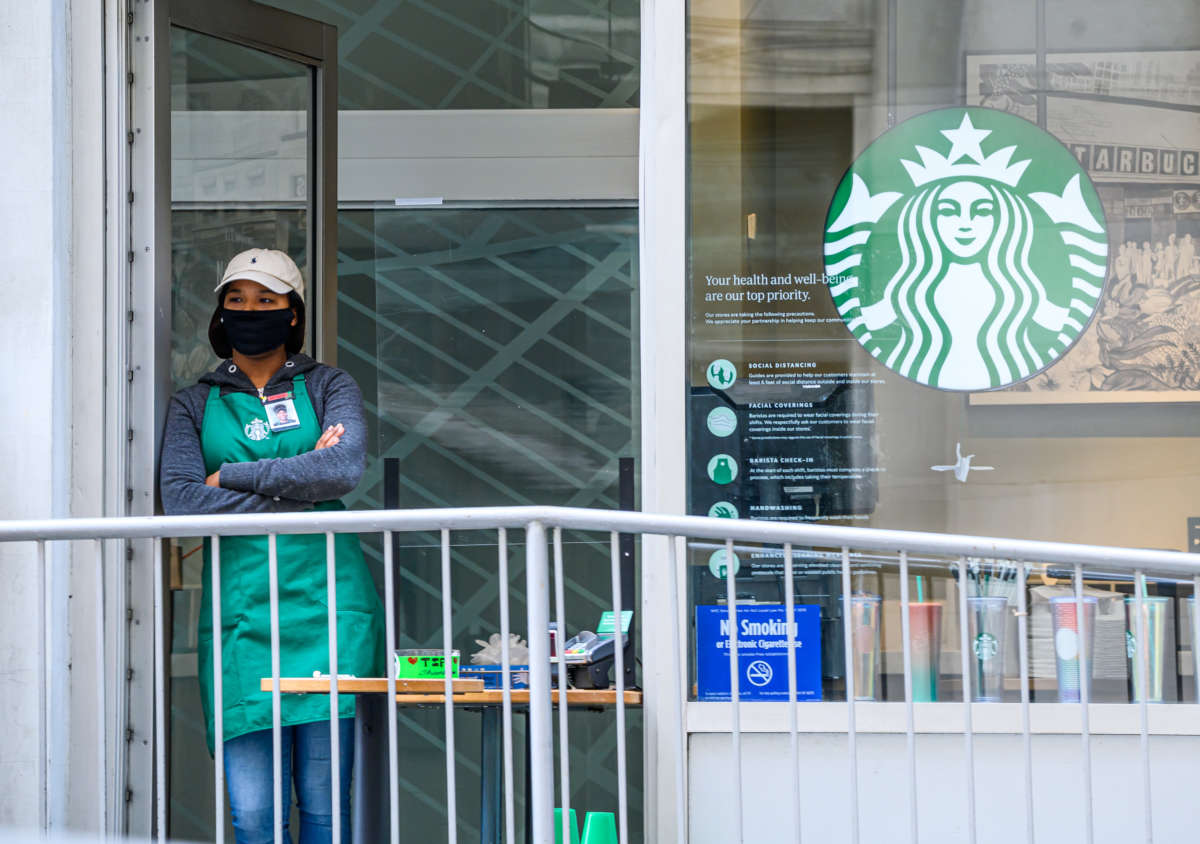 A worker stands inside Starbucks in midtown on May 20, 2020, in New York City.